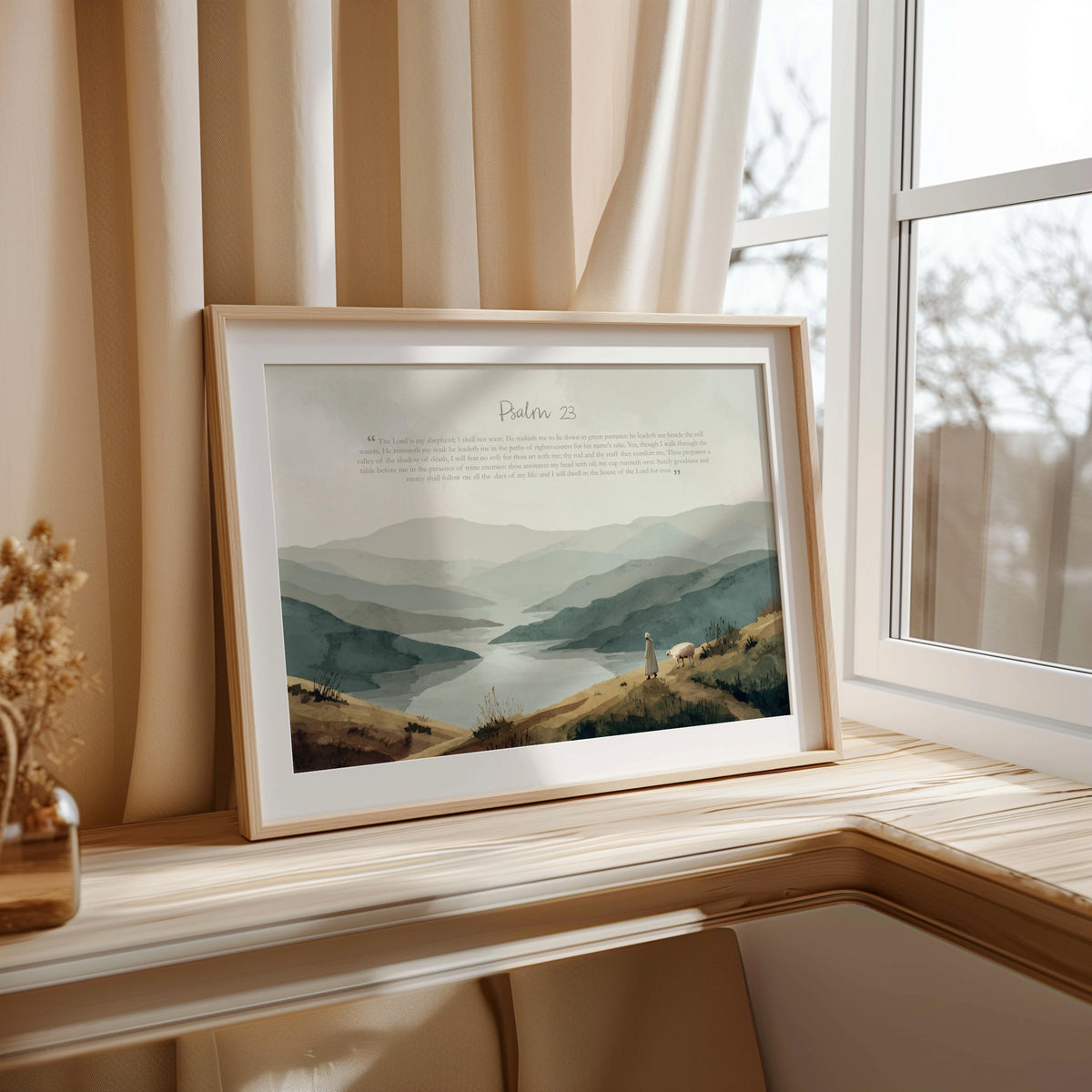 Window-side framed Psalm 23 wall art print leaning on sill, morning light on serif scripture and soft hills