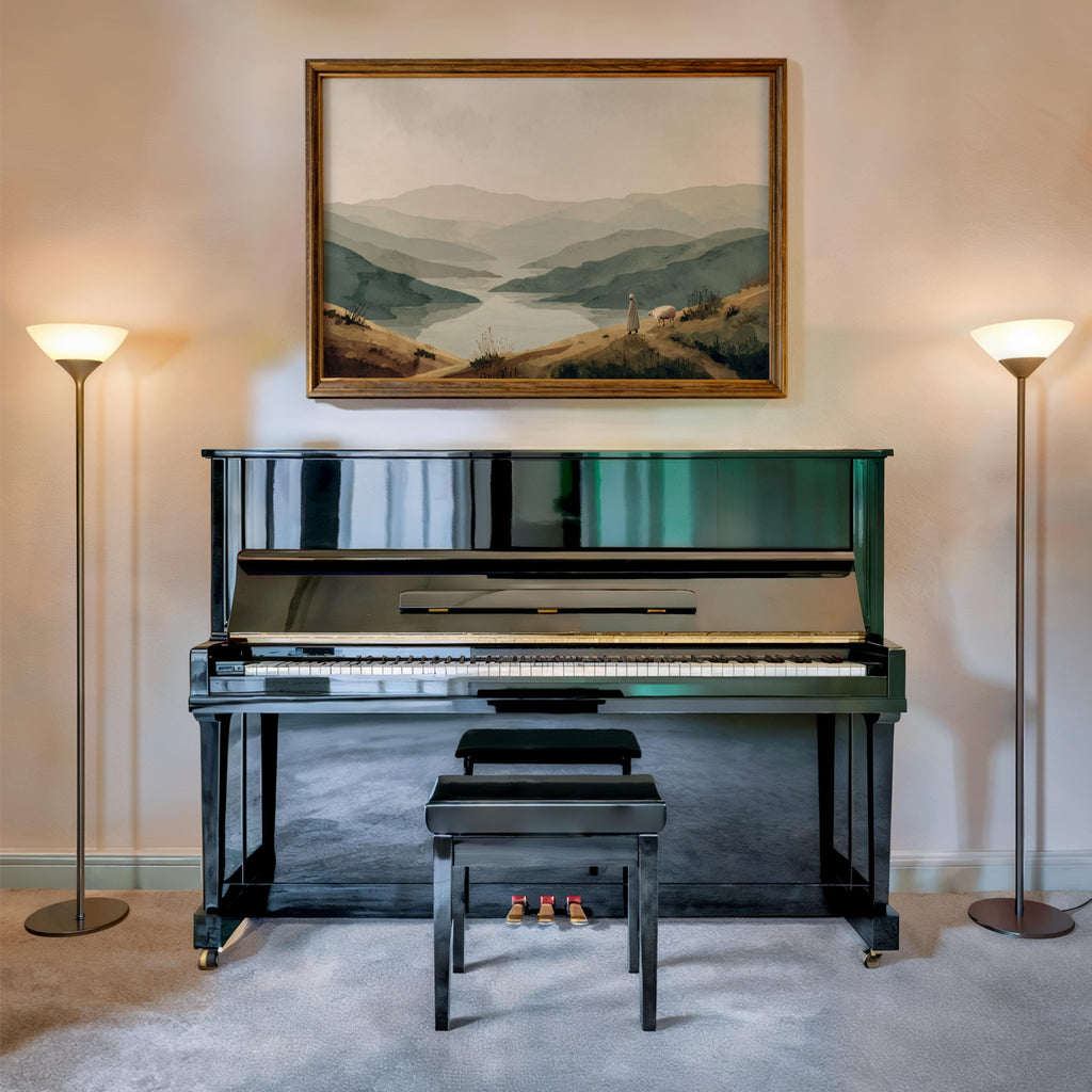 Psalm 23 wall art print centered above black piano, symmetrical lamps, neutral christian home decor styling
