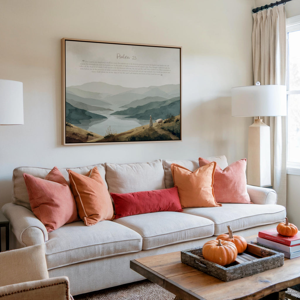 Large framed Psalm 23 wall art print above sofa, coral cushions and Scandinavian living room styling