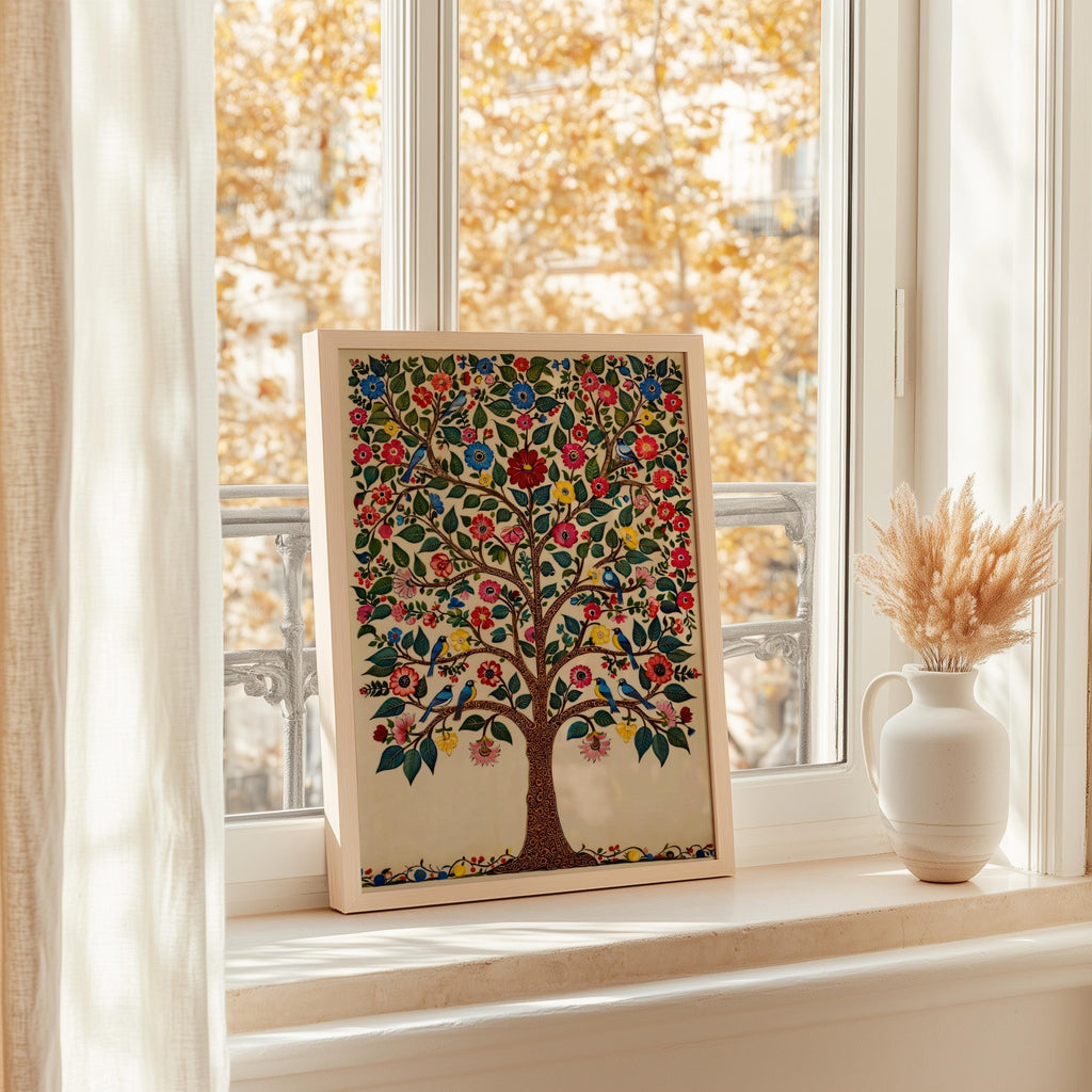 A framed painting of a colorful tree with flowers is displayed on a windowsill, with a vase of dried flowers next to it.