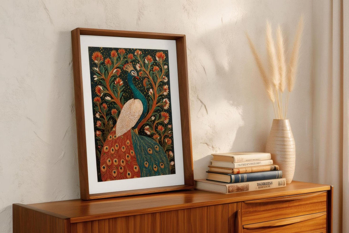 a framed painting of a peacock, a decorative vase with dried flowers, and a stack of books on a wooden dresser.