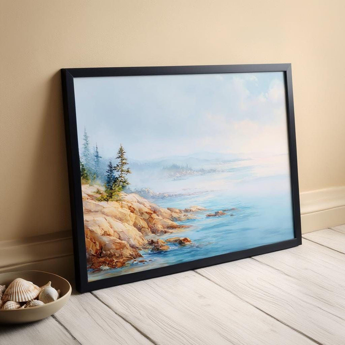 a framed painting of a serene coastal landscape, with a rocky shoreline, trees, and a body of water in the background.