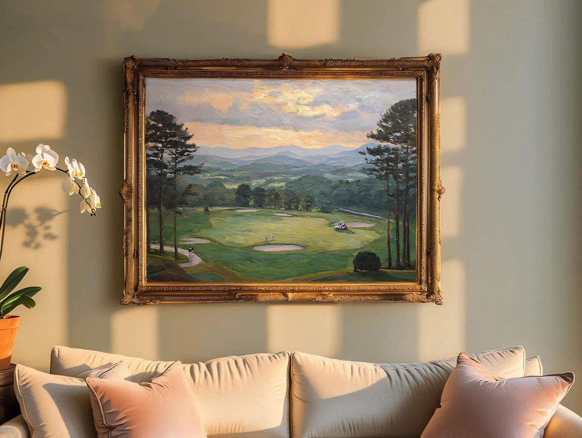 a large painting of a golf course hanging on a wall above a beige couch with pink pillows.