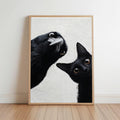 A framed painting depicting a black cat peeking out from behind a black bird, both with wide-open eyes and curious expressions.