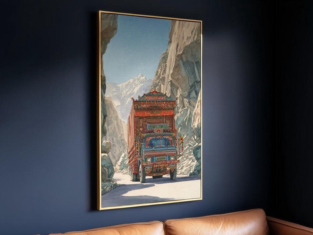 A large framed painting depicting a colorful truck driving through a mountainous landscape.