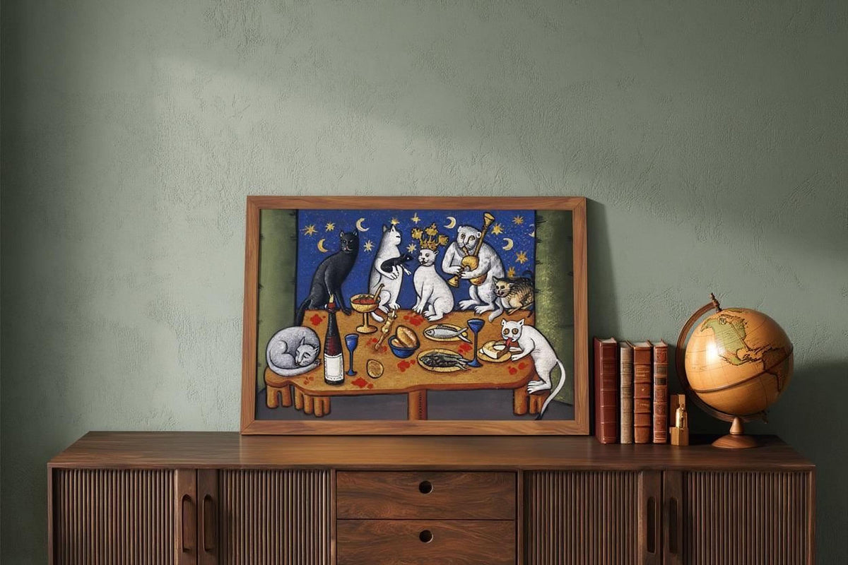 a wooden cabinet with a framed painting of cats sitting around a table, along with a globe and some books.