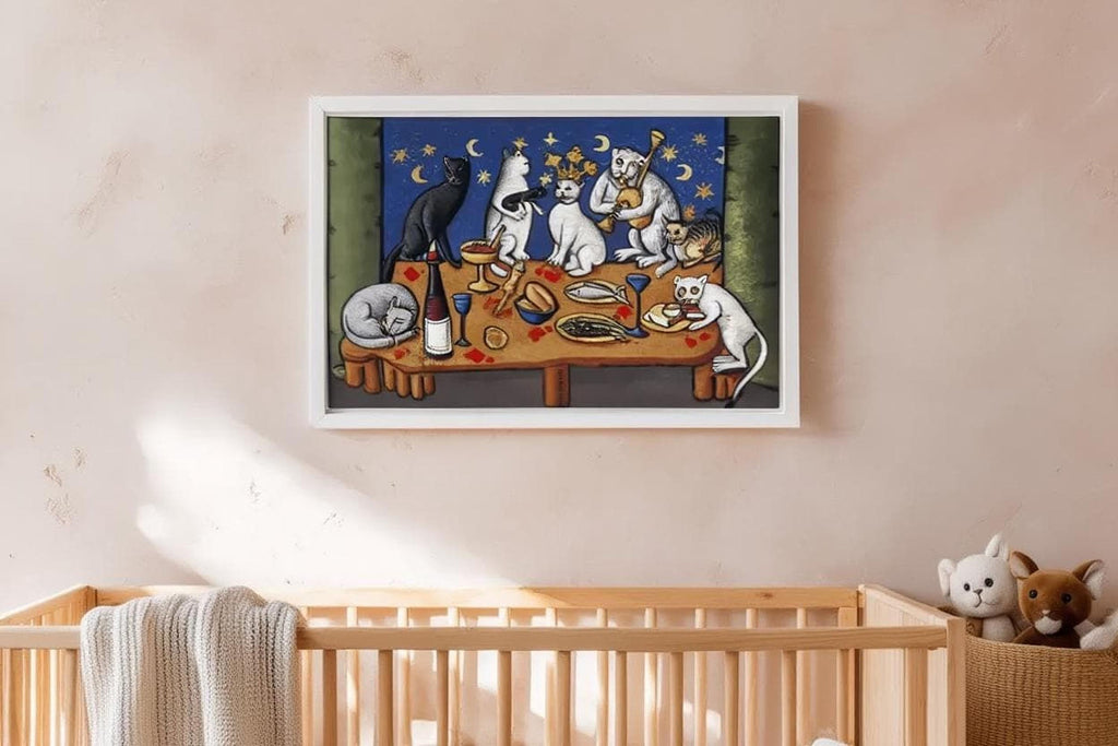 a framed painting of cats sitting around a table with food, including a wine glass, a bowl, and a cake.