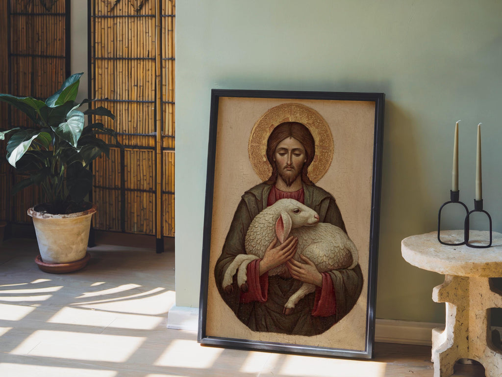 a framed painting of Jesus Christ holding a lamb, with a potted plant and candles in the background.