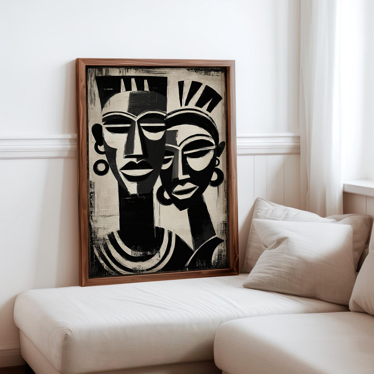 a large black and white abstract painting of two stylized human faces, hanging on a wall in a living room setting.