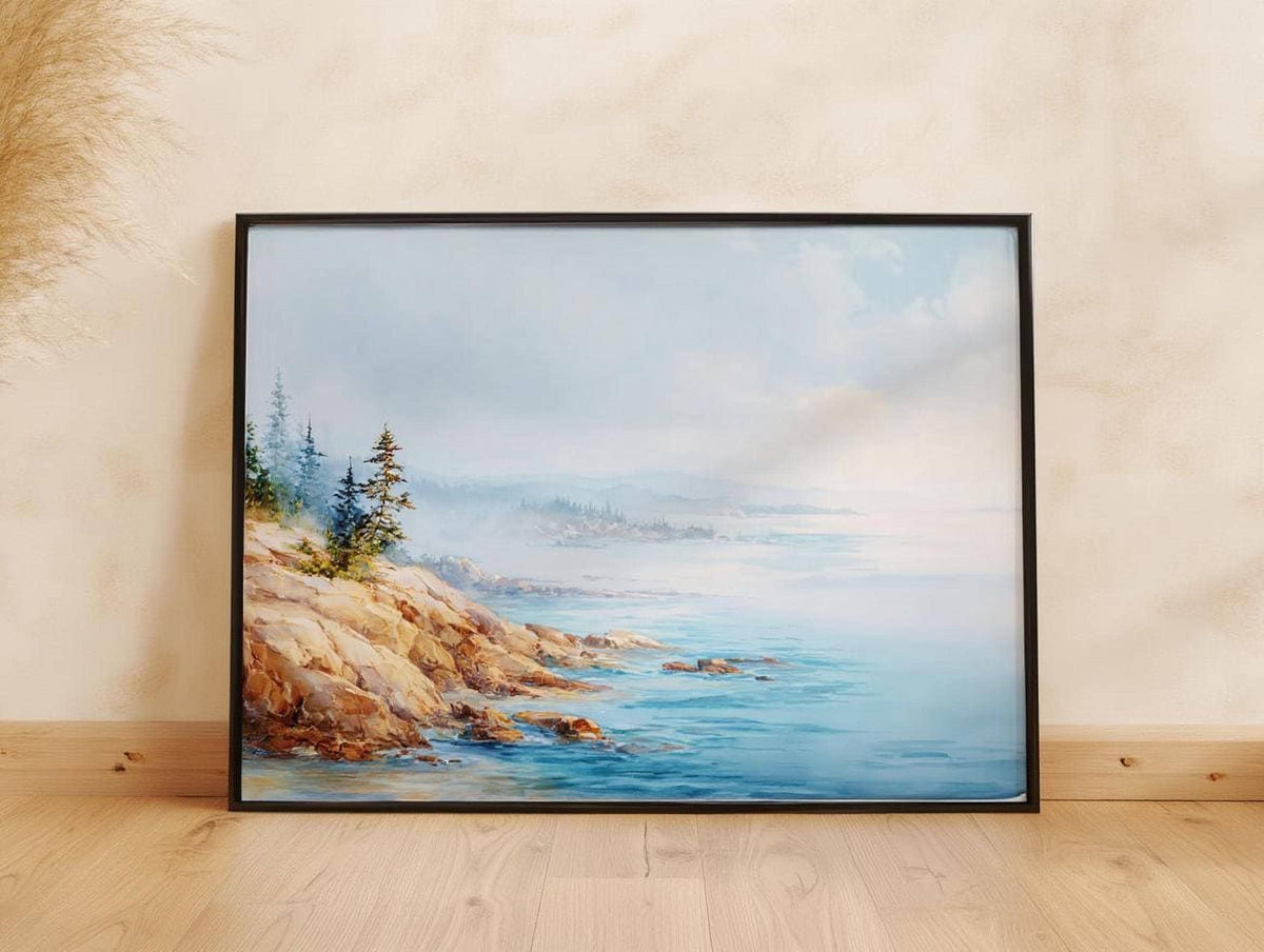A framed painting depicting a serene landscape with a rocky coastline, trees, and a body of water.