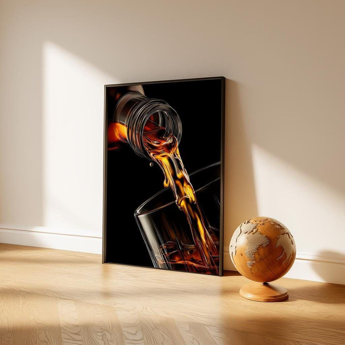 a framed photograph of a glass with a liquid pouring out, and a globe on a wooden stand next to it.