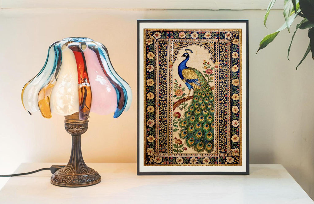 a lamp with a colorful glass shade and a framed picture of a peacock on a table.