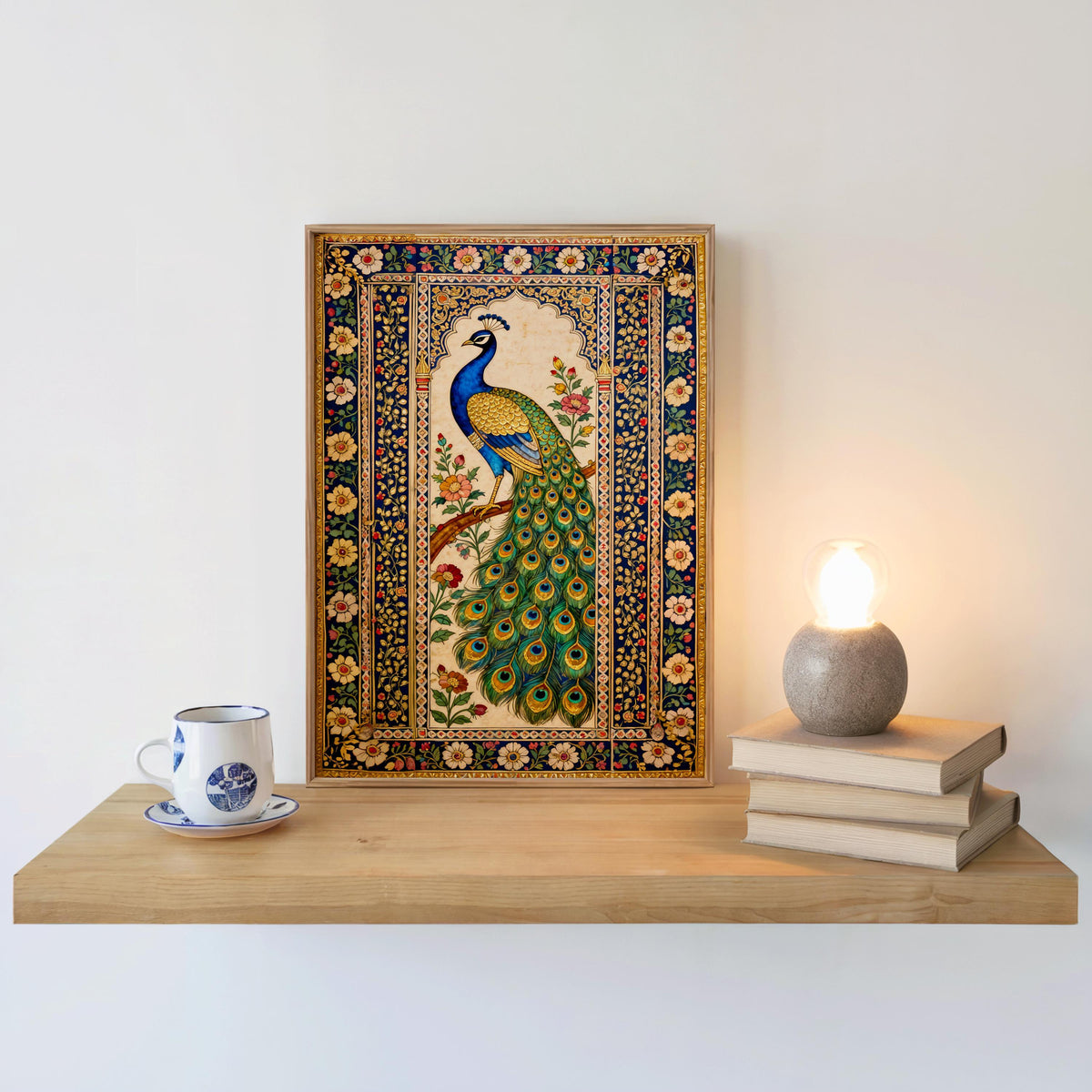 a wooden shelf with a framed painting of a peacock, a white coffee cup, and a stack of books.