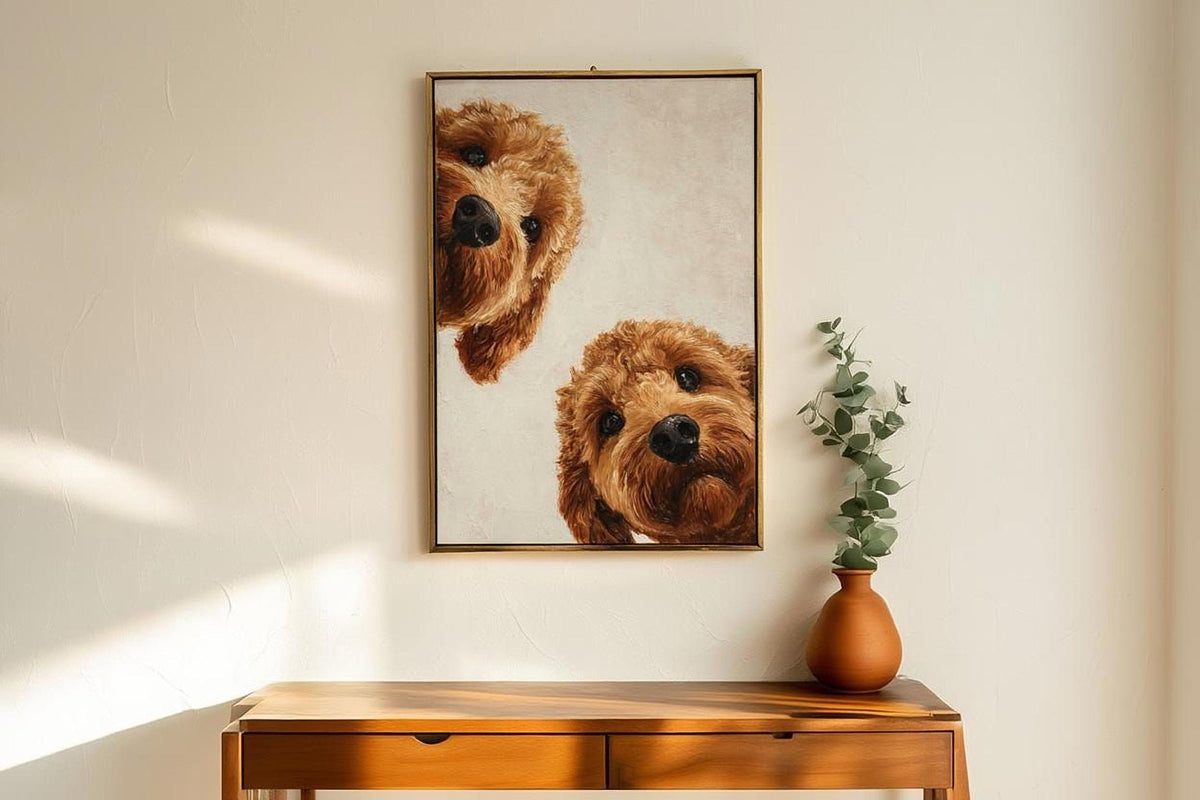 a wooden table with a vase of greenery and a framed painting of two brown dogs peeking out from behind the frame.
