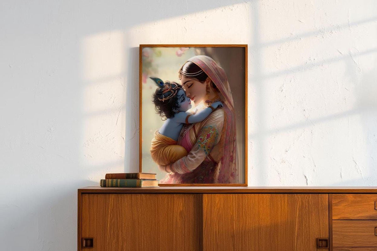 A framed painting of a woman embracing a child, likely a depiction of the Hindu deity Radha, is displayed on a wooden cabinet against a white wall.