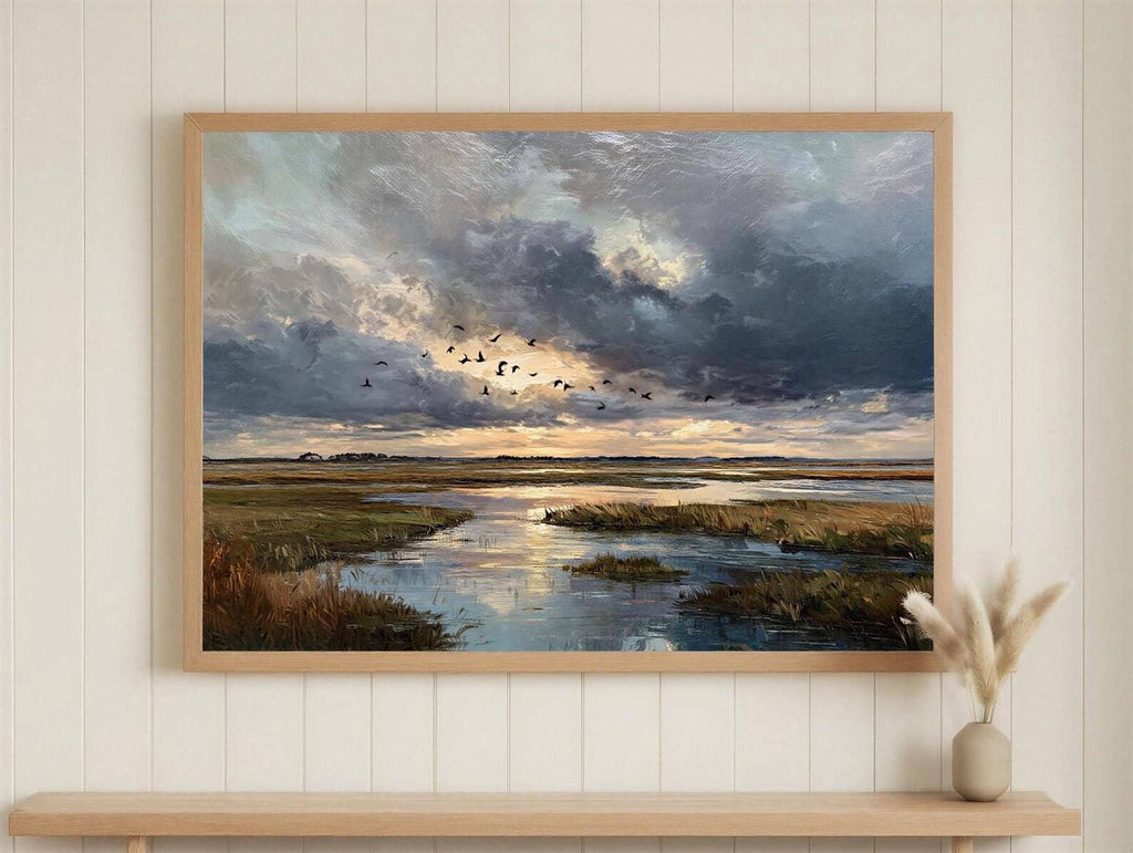 The image is a framed painting depicting a serene landscape with a river, birds flying in the sky, and a dramatic cloudy sky.