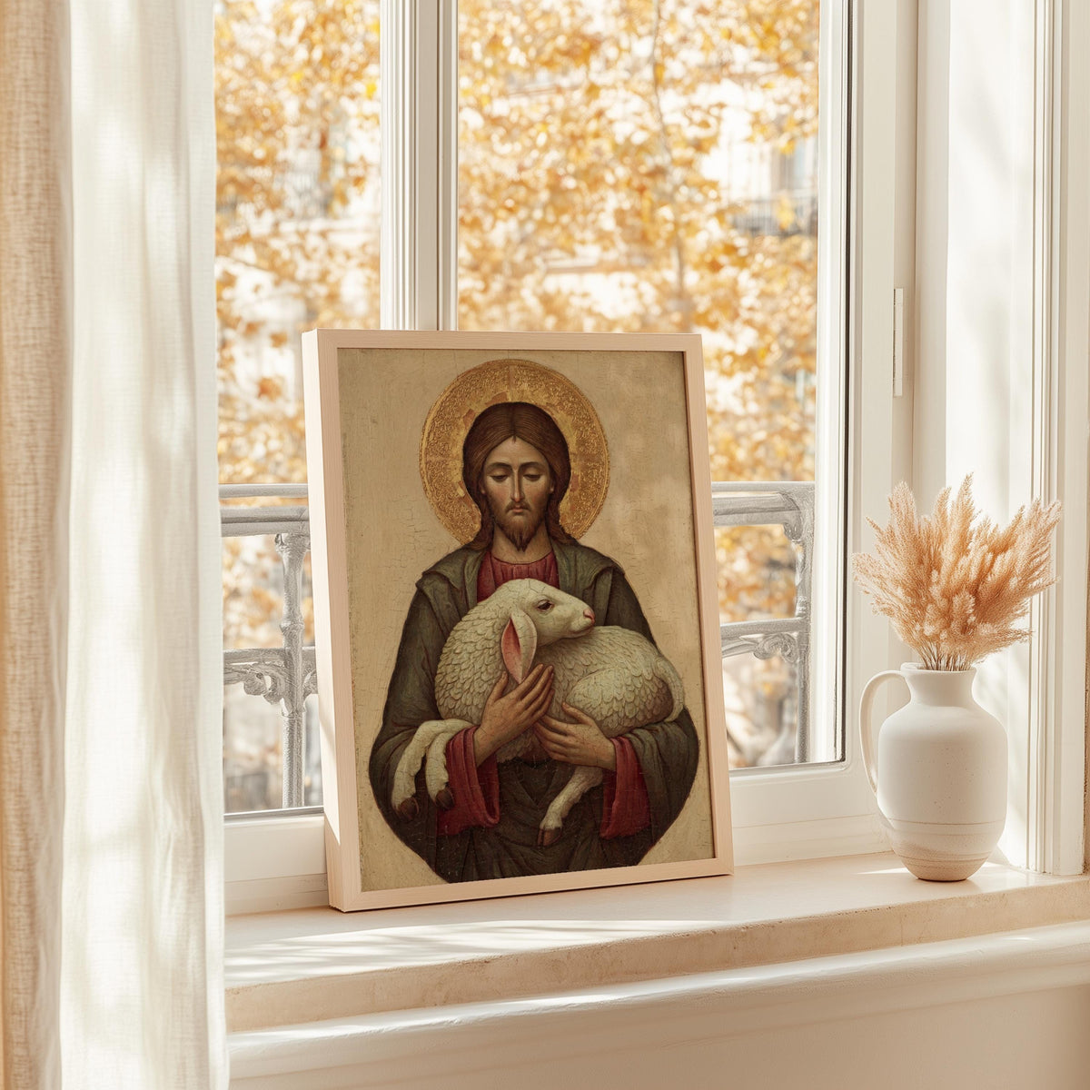 a framed painting of Jesus Christ holding a lamb, placed on a windowsill.
