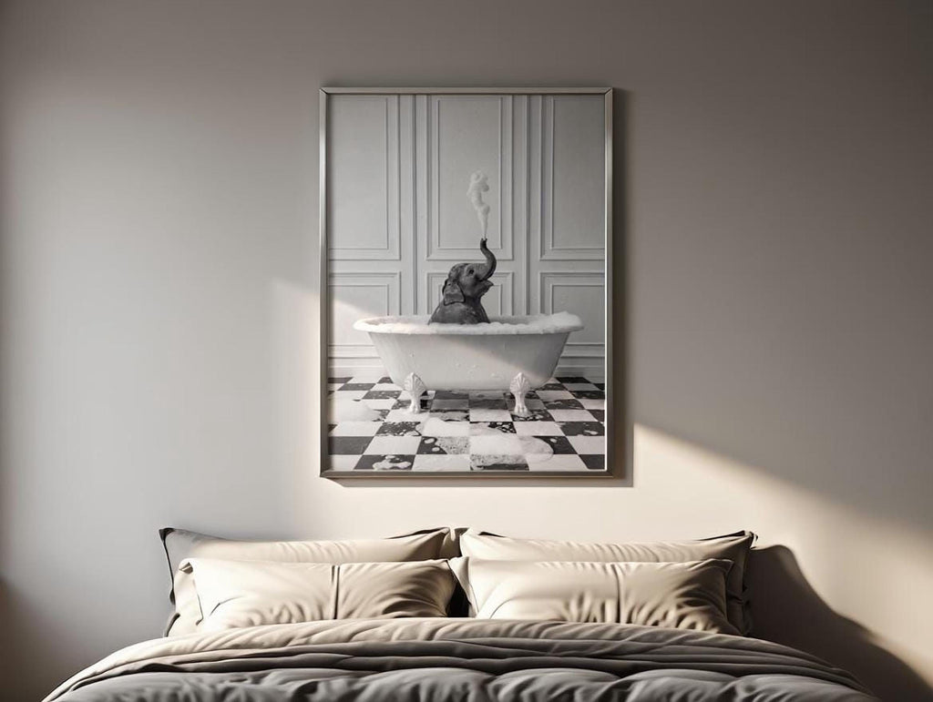 A framed black and white photograph of an elephant sitting in a bathtub, with a checkered floor beneath it.