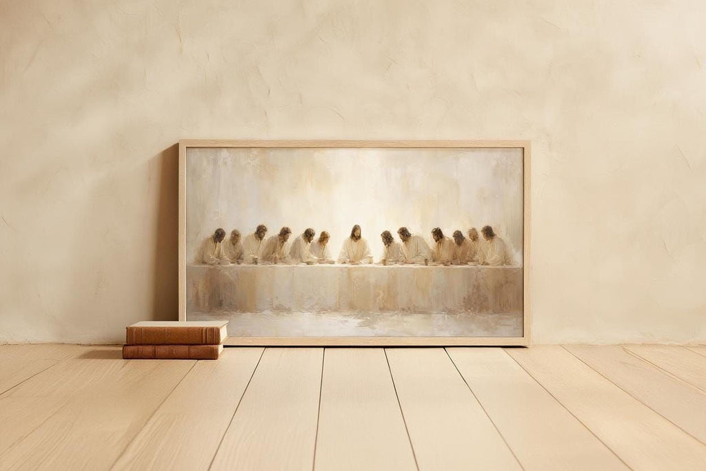 a framed painting of a group of people sitting at a table, with a book and a stack of books placed next to it on a wooden floor.