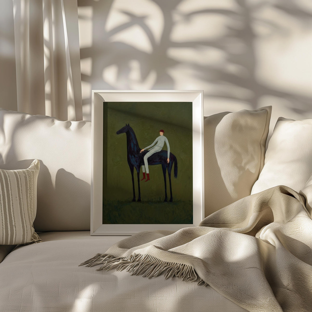 Horse painting print on cozy sofa, vertical framed equestrian artwork with olive green background and throw.
