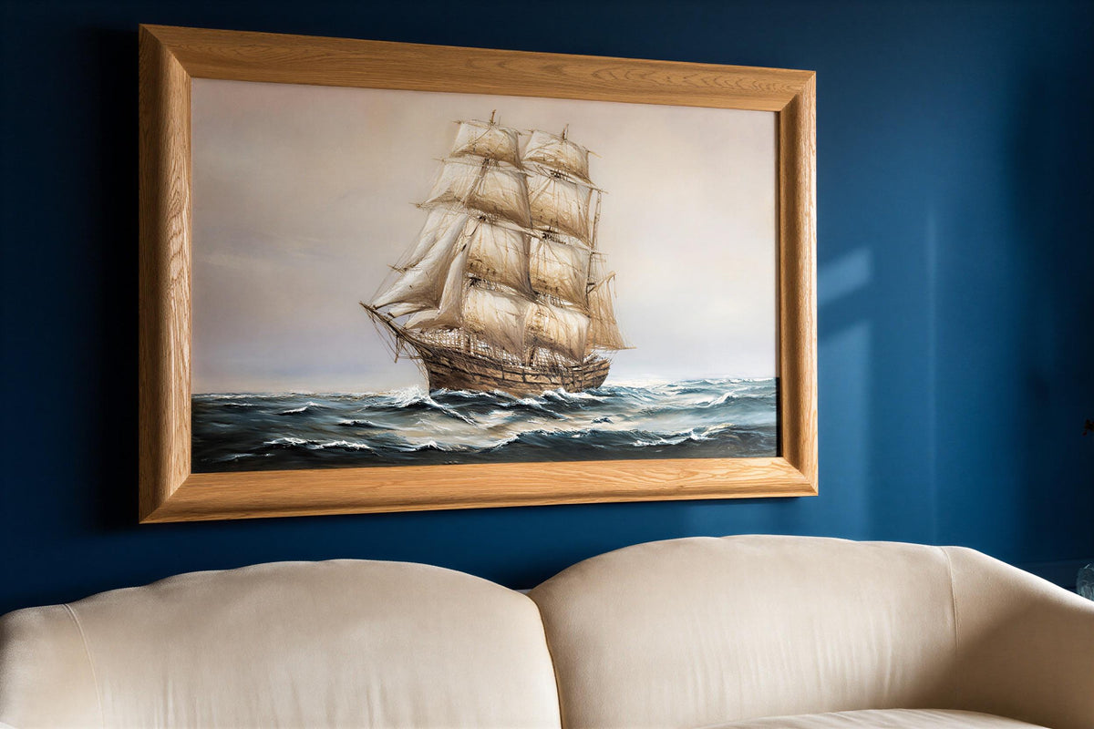 Antique tall ship canvas for nautical wall art; billowing sails on a moody navy blue seascape framed in ornate gold.