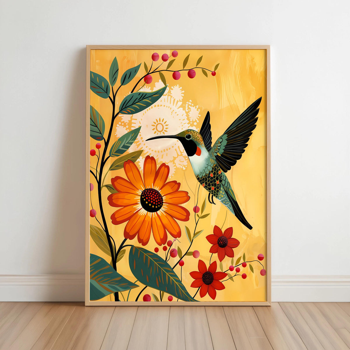 Framed hummingbird wall art print leaning on floor, light wood frame, mustard yellow backdrop with bold orange marigold flowers.