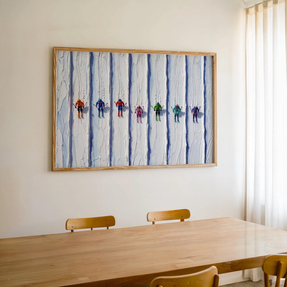 Vintage ski art print hung above Scandinavian dining table, colorful tiny skiers brighten the room