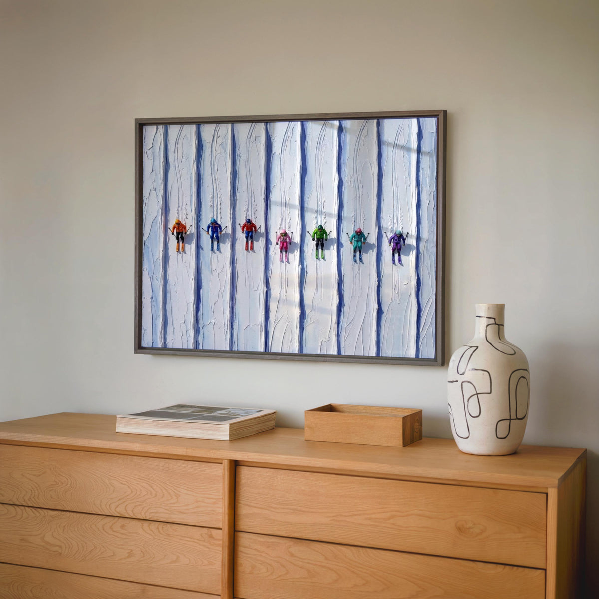 Vintage ski art print above a wood sideboard, palette knife snow texture and cool blue tones