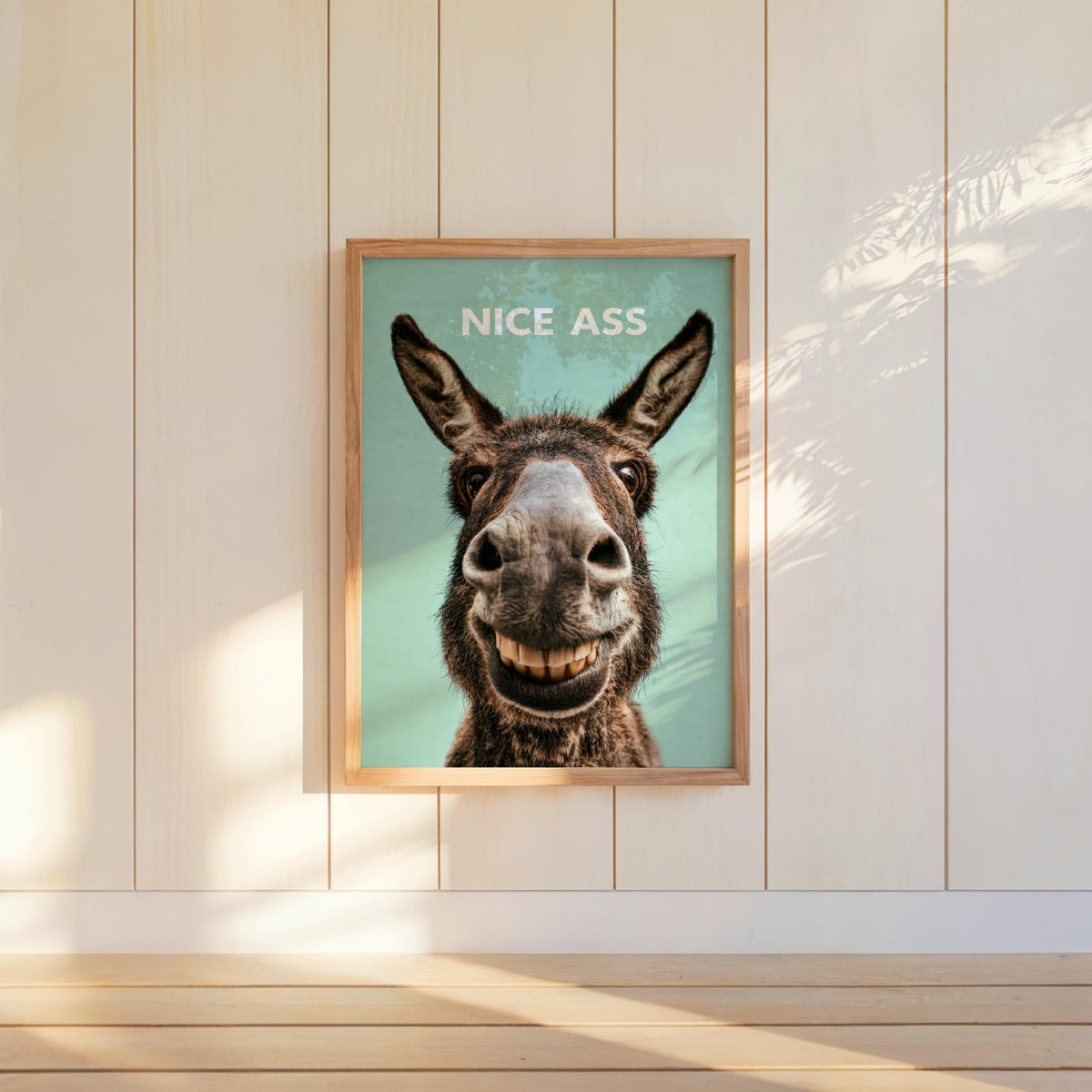 Minty green funny donkey bathroom sign centered on paneled wall, toothy donkey smile, nice ass print style
