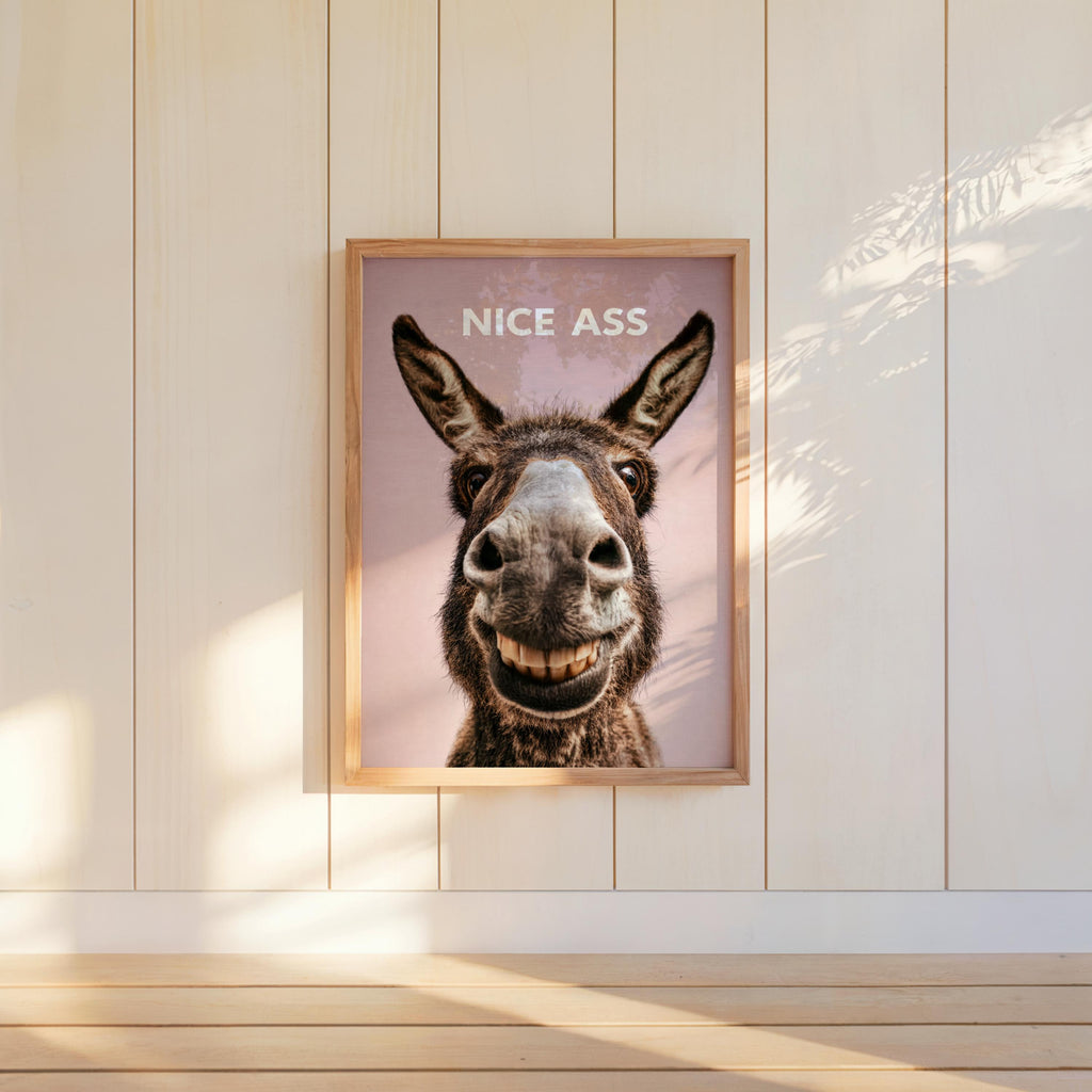 Narrow wall framed funny donkey bathroom sign with mauve background, close up donkey face, cheeky restroom decor