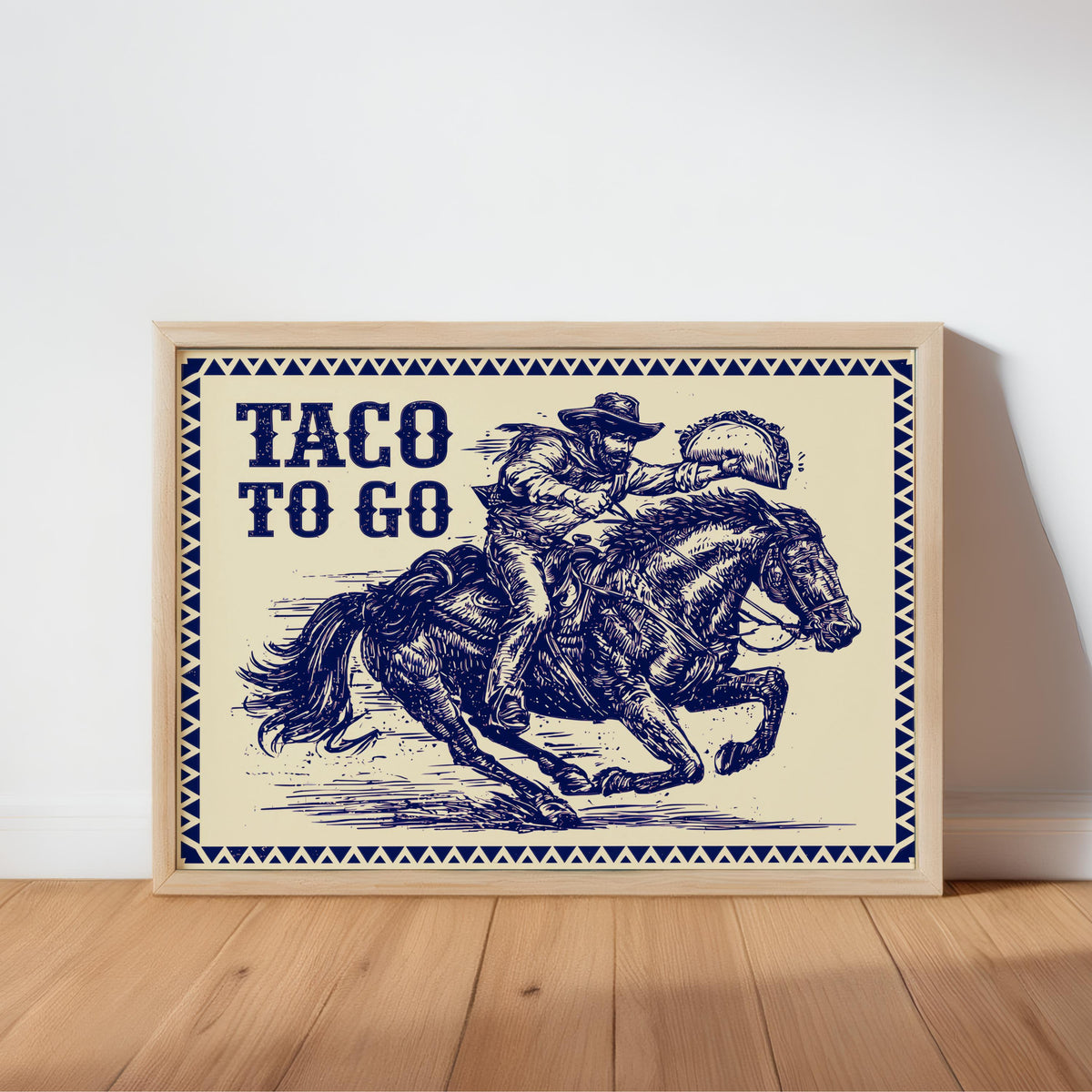 Framed navy ink cowboy on horseback, leaning against wall on wood floor, funny cowboy kitchen wall art with parchment tones