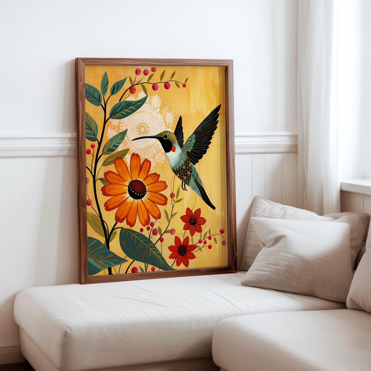 Hummingbird floral wall art print leaned against white sofa, light wood frame, mid century modern bird art vibe.
