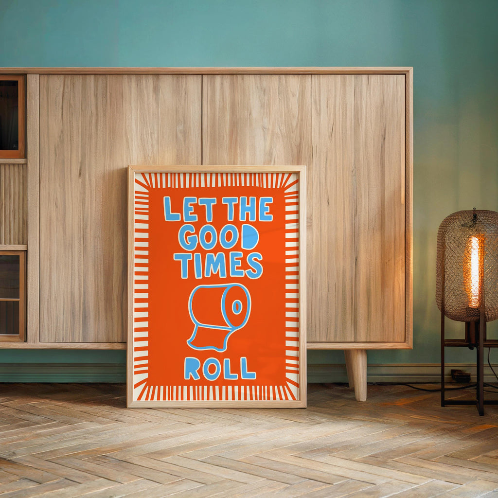 Orange poster leaning by cabinet in teal room, bold toilet paper illustration, guest bathroom wall decor with humor