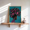 Framed teal variant leaning on a shelf, vinyl-record afro with pink labels, warm light, black woman vinyl record wall art