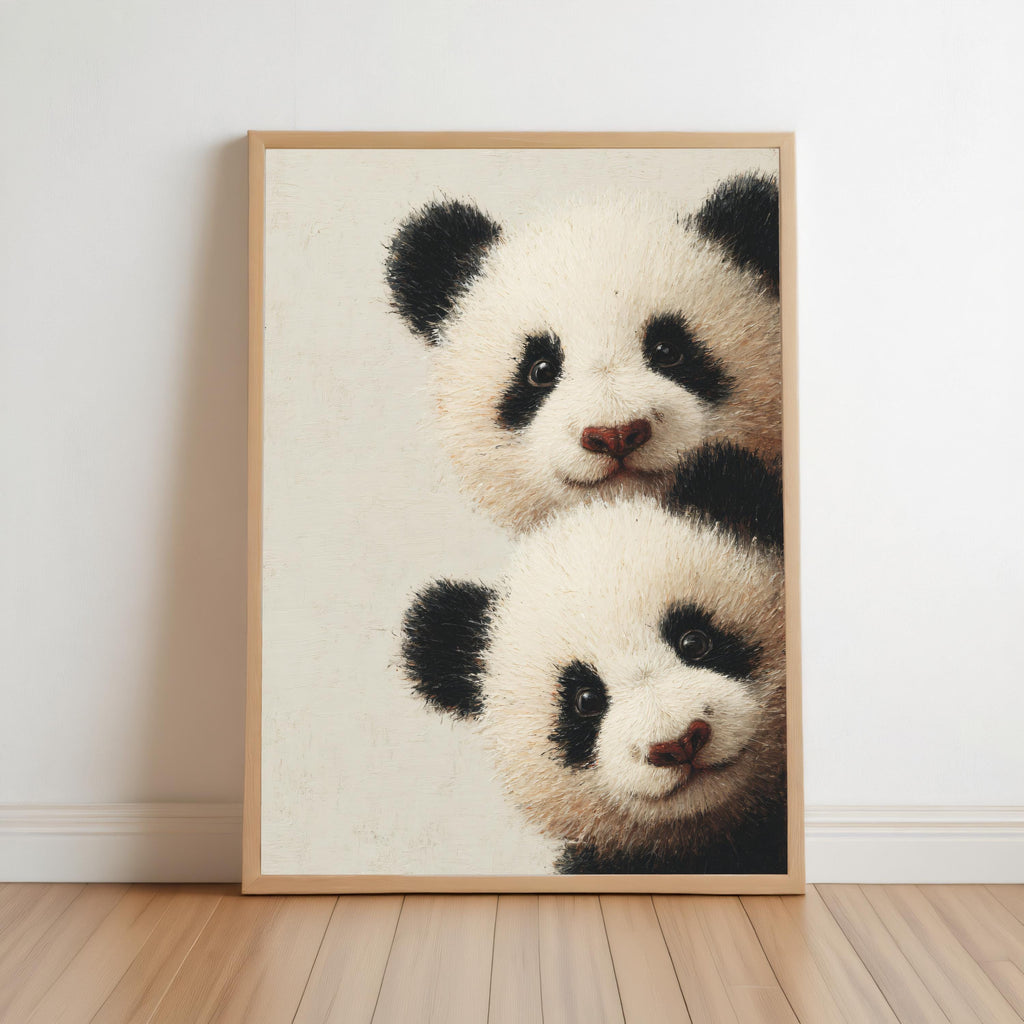Baby pandas wall art: two giant panda cubs peeking from the edge in a light-wood framed print for baby panda nursery decor.