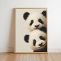 Baby pandas wall art: two giant panda cubs peeking from the edge in a light-wood framed print for baby panda nursery decor.