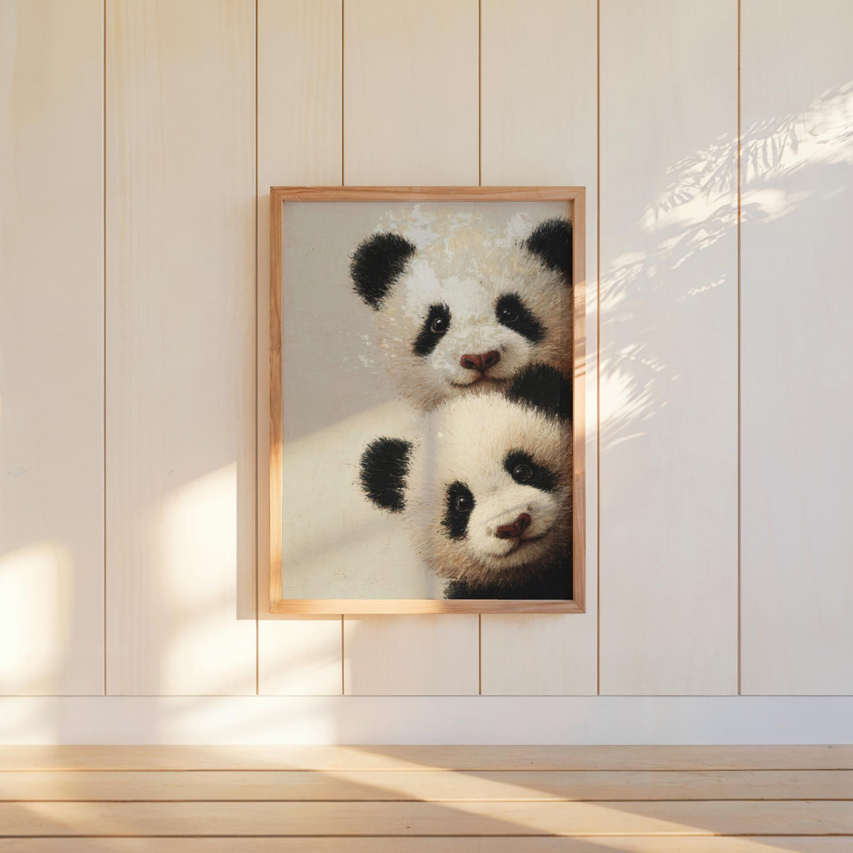 Baby pandas wall art: two giant panda cubs peeking from the edge in a light-wood framed print for baby panda nursery decor.