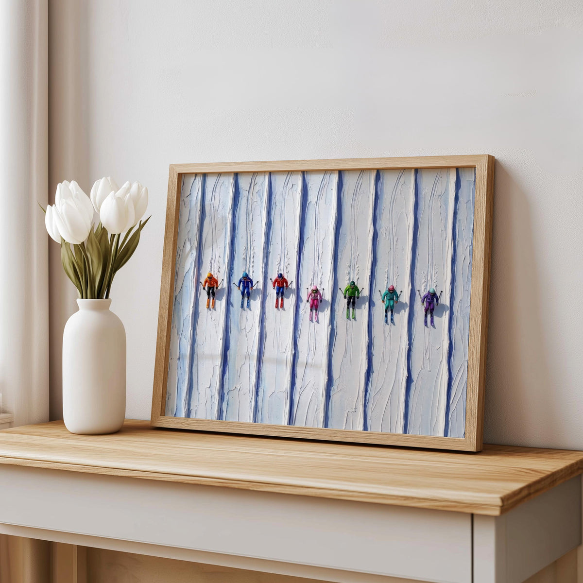 Framed vintage ski art print on a console shelf, white vase with tulips, textured impasto ridges