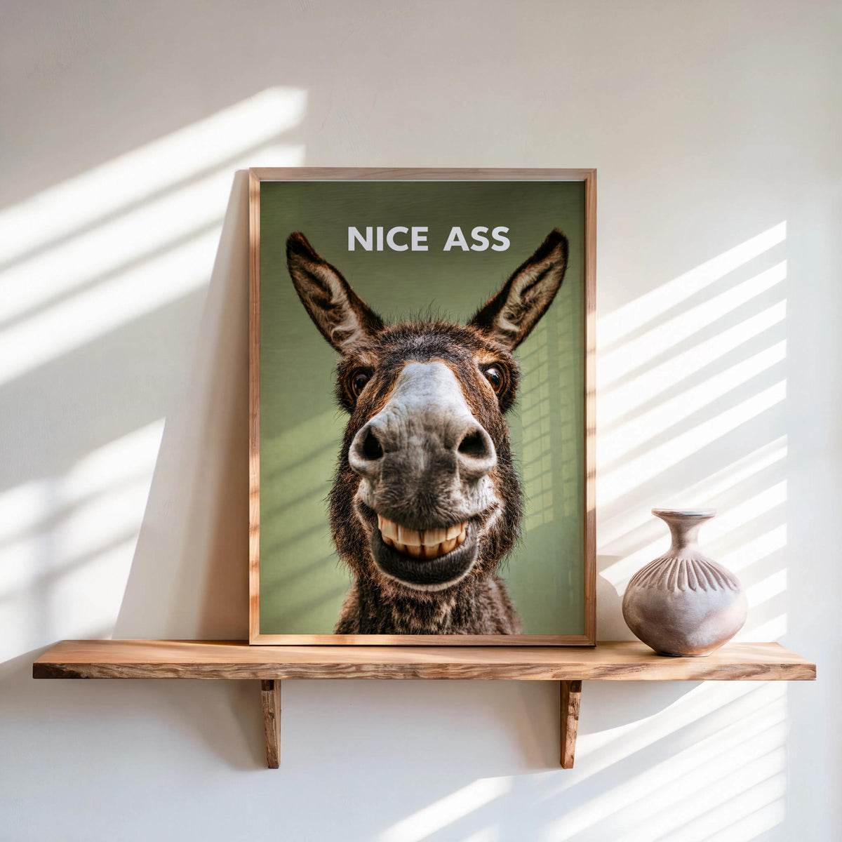 Olive green funny donkey bathroom sign on floating shelf, bold white NICE ASS headline, rustic poster look