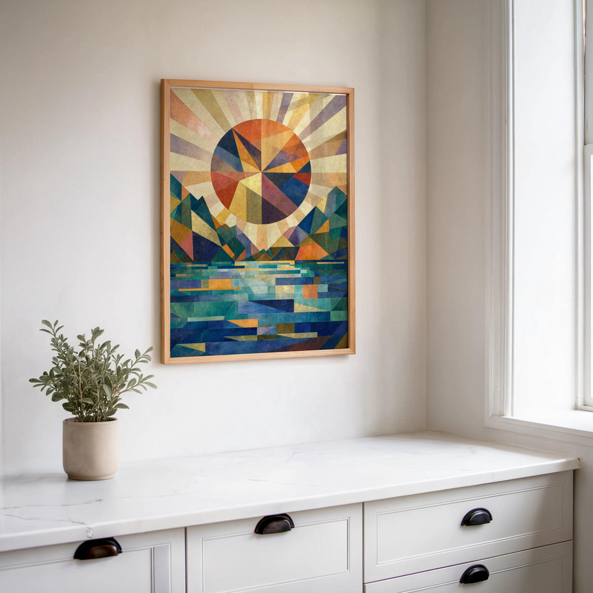 Large framed abstract mountain sunset wall art above a white kitchen counter, modern mountain wall art styling and light wood frame