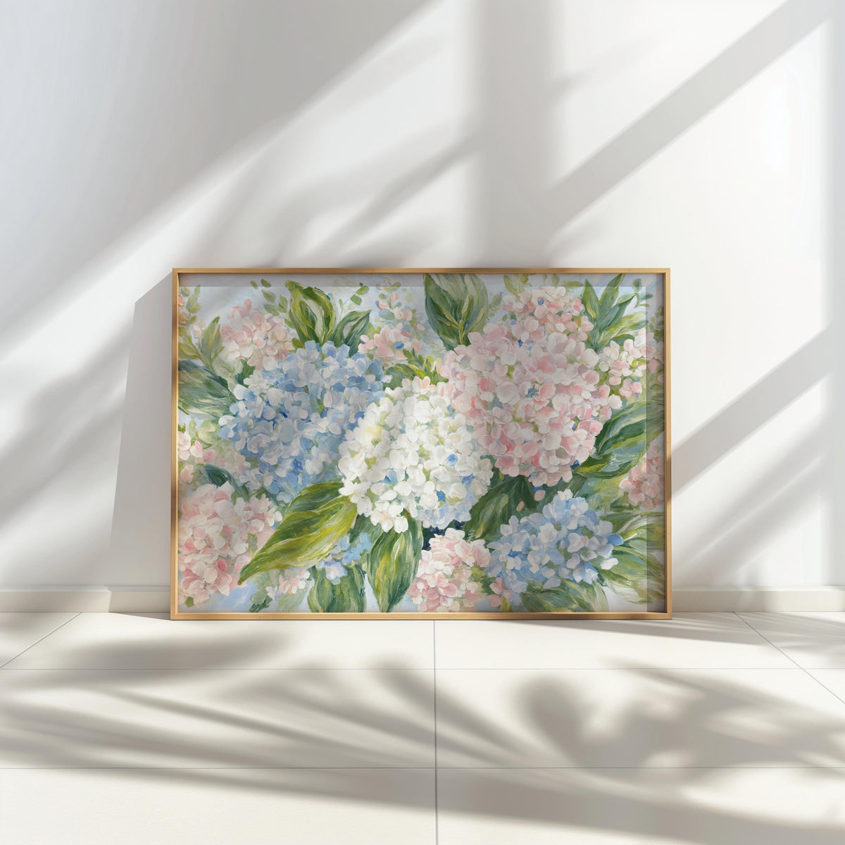 Sunlit shelf display, framed pastel hydrangea wall art, crisp shadows highlighting blue and pink blooms