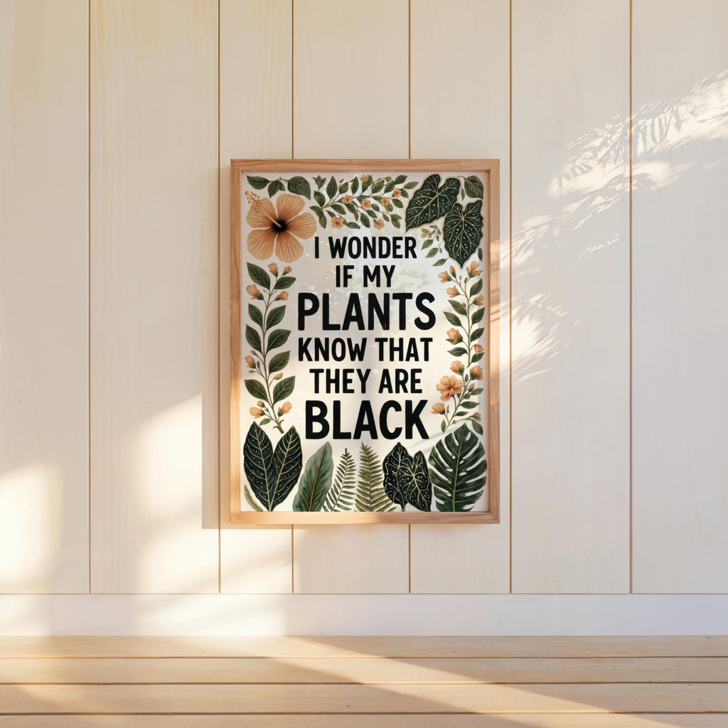 Framed print centered on pale shiplap wall, warm light highlights foliage border, black plant lover wall art