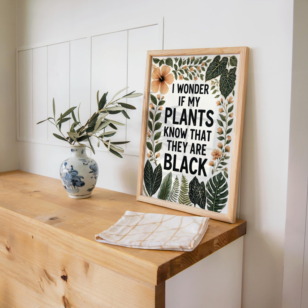 Wood desk styling with vase and planner, framed print leaning, afrocentric plant lover decor, black plant lover wall art
