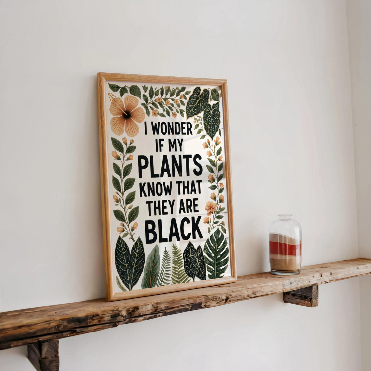 Rustic shelf display with framed print and small glass, warm neutrals accenting tropical black plant lover wall art