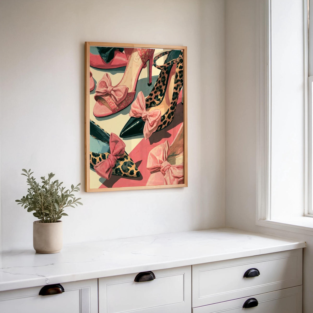 Luxury fashion poster hung above a white console, small plant, coral and green palette, vintage shoe collage