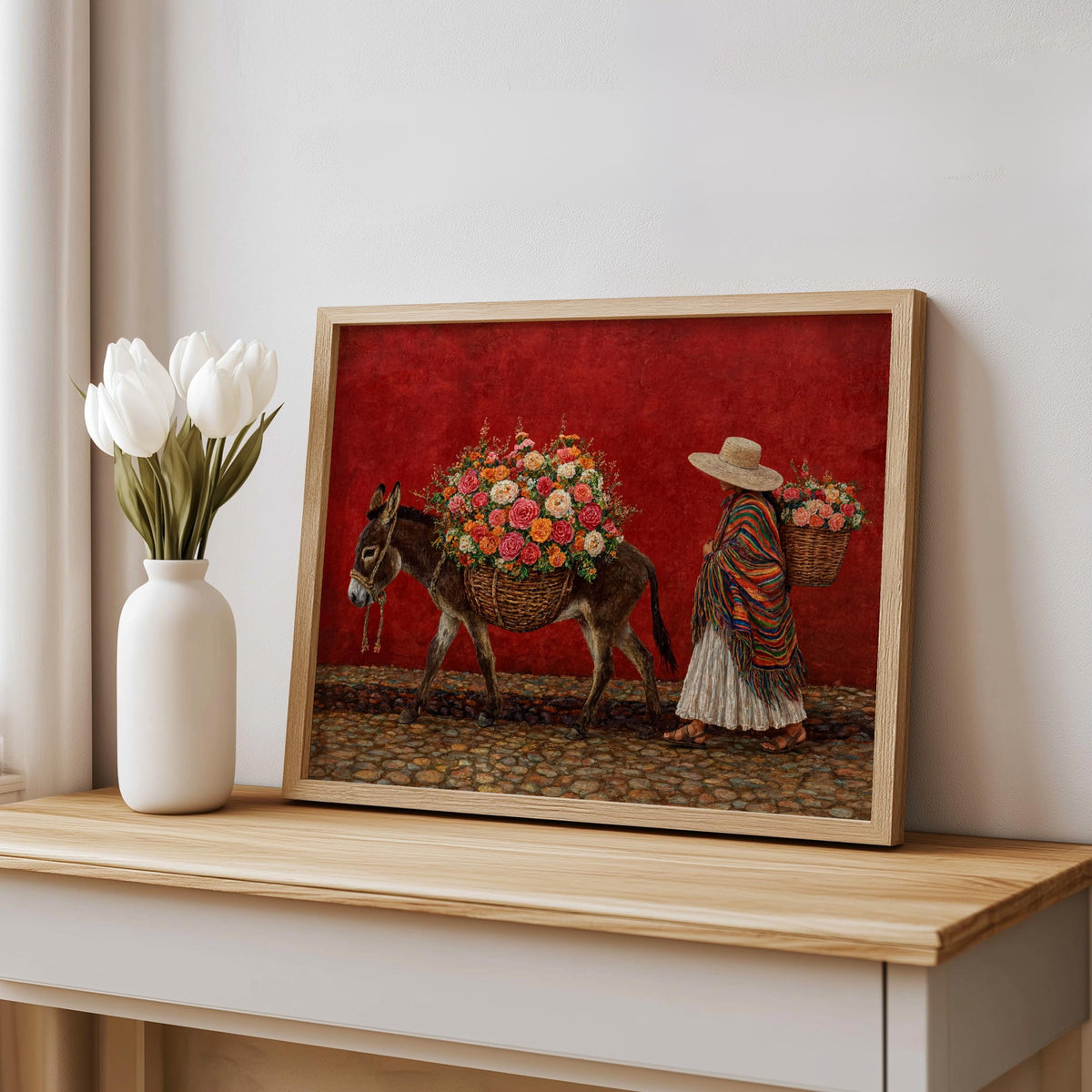 Bold mexican folk art wall art leaning on console, deep red backdrop, woman in serape and flower-laden donkey, textured paint feel