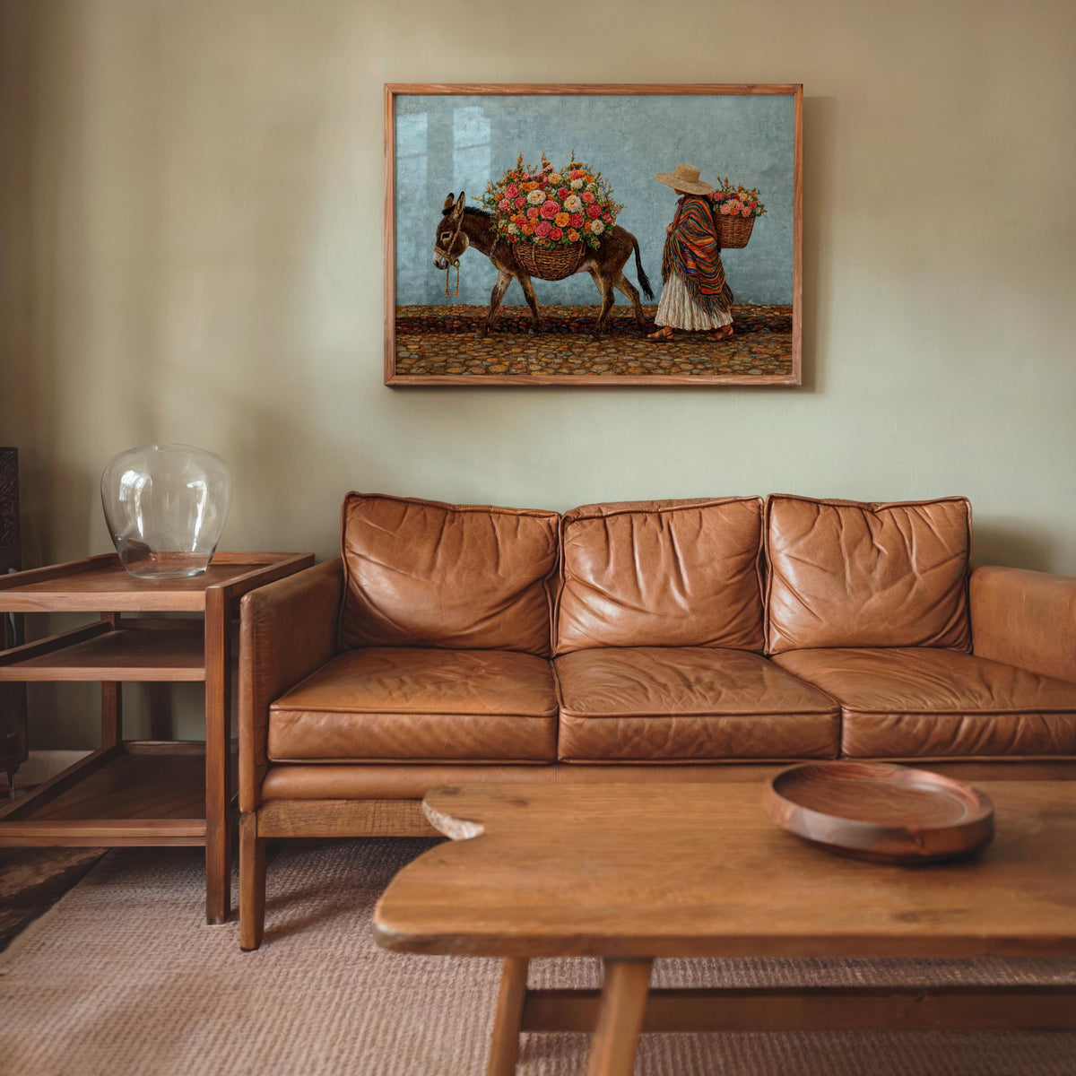 Colorful mexican wall art above couch, turquoise sky background, folk style donkey and vendor, saturated boho palette