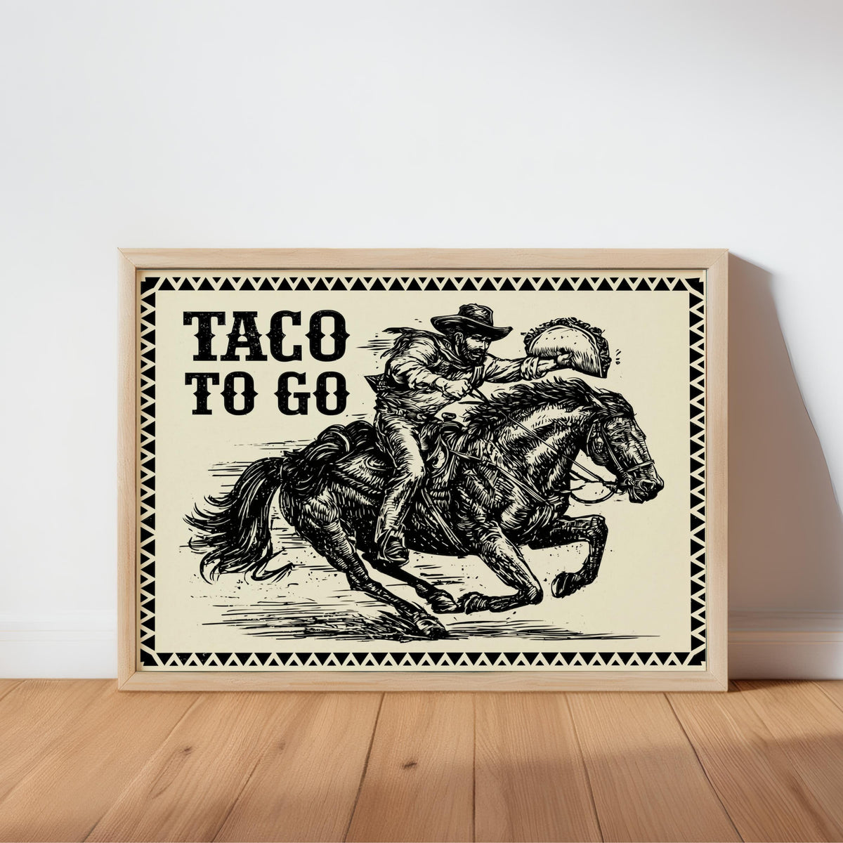 Black ink vintage western engraving, light wood frame leaning on baseboard, taco wall art print with warm parchment
