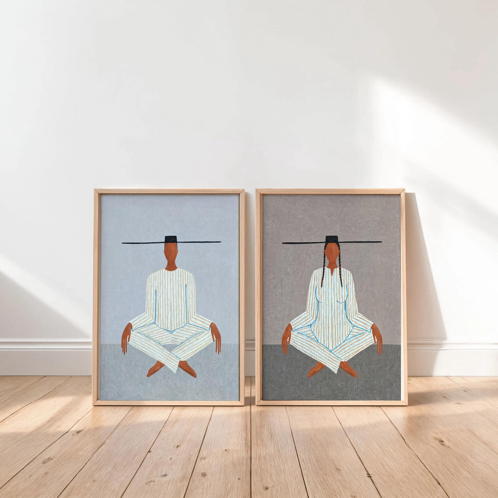 Clean scene with two unframed light blue prints on floor, meditating figure art print pair, modern figurative art