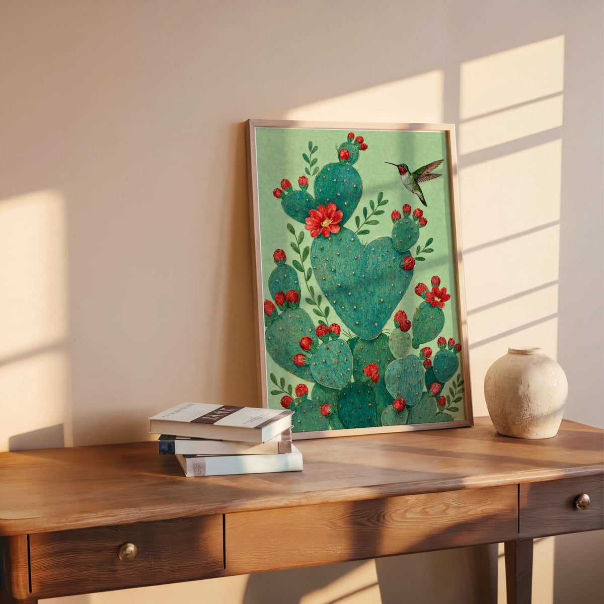 Heart shaped cactus print leaning on desk by window, warm late light, Southwestern wall decor vibe